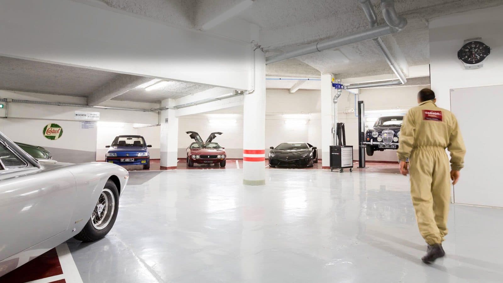 Le sous-sol du Garage MMC : sol blanc, voitures de collection alignées
